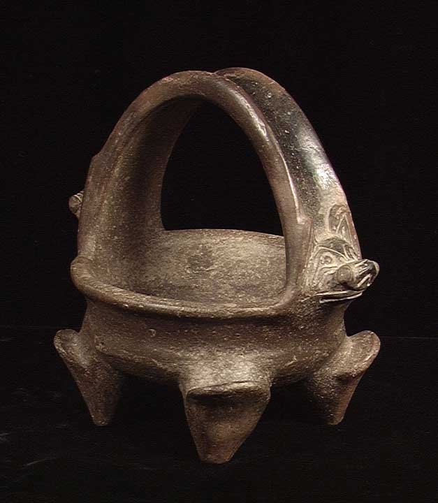 TAIRONA ZOOMORPHIC VESSEL WITH BATS: TAIRONA ZOOMORPHIC VESSEL WITH BATS. Columbia, ca. 800 AD. The four legged vessel with high handle arching over the bowl, bat heads emerging from both sides of the handle. 5 x 5.25 inches. Provenance: