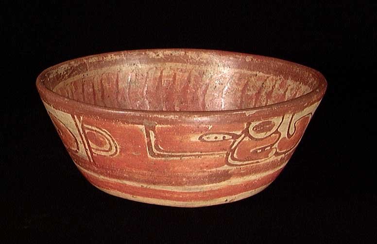 MAYAN POLYCHROME BOWL: MAYAN POLYCHROME BOWL, ca. 600-800 AD. The bowl with a band of chief's heads encircling the sides, the interior with a large solar symbol, all done in red and orange. 3 x 7.3 inches. Provenance: An ex