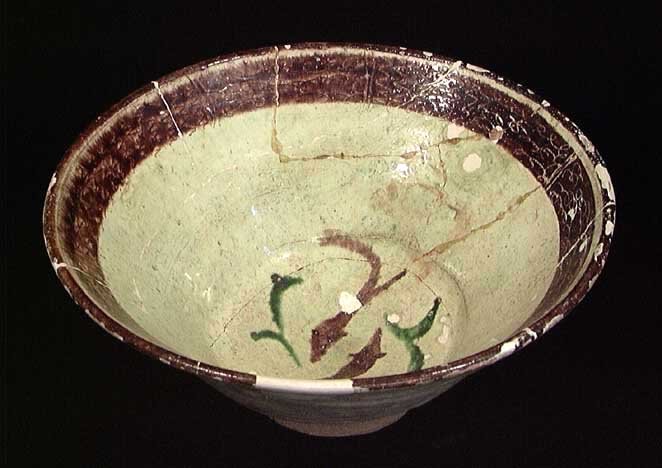 EX CHRISTIE'S EARLY PERSIAN BOWL: EX CHRISTIE'S: EARLY PERSIAN BOWL, ca. 12th-13th century AD. The bowl with brown and green fishes on a chartreuse ground, a band of incised sgraffiato curlicue designs under brown glaze around the rim