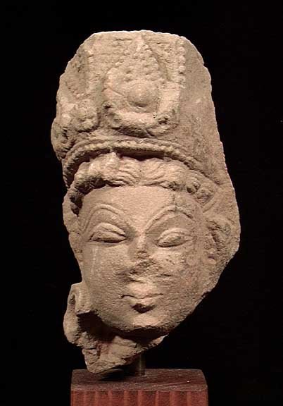EARLY INDIAN STONE HEAD OF A PRINCE: EARLY INDIAN STONE HEAD OF A PRINCE, ca. 10th century AD. Wearing a tall royal headdress. 5 inches. On custom stand. Provenance: Purchased by the current owner from a New Jersey collection in the 1990