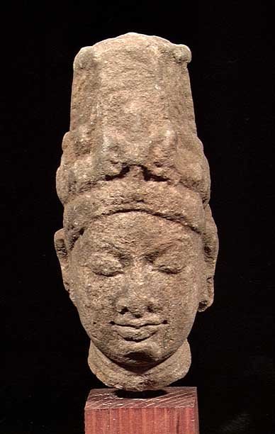EARLY INDIAN STONE HEAD OF A PRINCE: EARLY INDIAN STONE HEAD OF A PRINCE, ca. 10th century AD. Wearing a tall royal headdress. 5 inches. On custom stand. Provenance: Purchased by the current owner from a New Jersey collection in the 1990