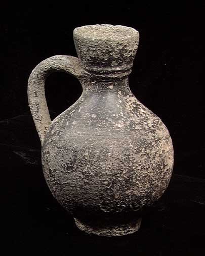 ELEGANT HOLY LAND GREEK BLACK WARE PITCHER: ELEGANT HOLY LAND GREEK BLACK WARE PITCHER, Hellenistic, time of Christ or thereabouts. The jug with single handle from waist to neck. 4". Intact. Provenance: An extensive 20th century New Jersey coll