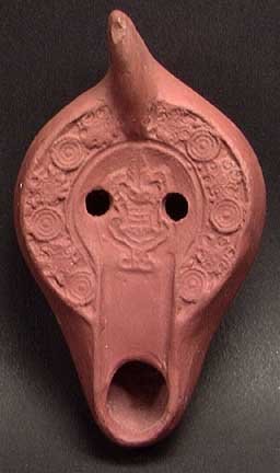 ROMAN REDWARE LAMP WITH KRATER: AN EARLY CHRISTIAN OIL LAMP, Roman North Africa, c. 4th-6th century. The redware lamp with a krater and other motifs on the discus. 4.5".Provenance: An extensive 20th century New Jersey collection ass