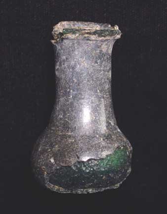 BYZANTINE BLACK GLASS BOTTLE: BYZANTINE BLACK GLASS BOTTLE, c. 4th-6th century AD. The vessel of thick opaque black-green glass with bulbous body, tall neck with rolled rim. 2.25 inches. Areas of surface lamination. Scarce type. P