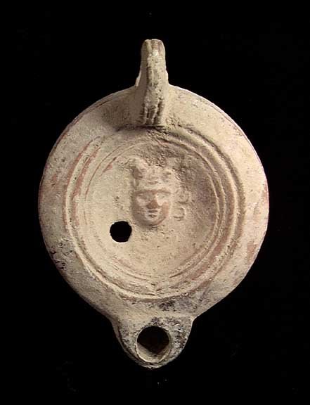 ROMAN MERCURY OIL LAMP: ROMAN FIGURAL OIL LAMP WITH FACING HEAD OF MERCURY, ca. 1st-2nd century AD. The lamp with the high profile facing head of Mercury with wings on his head adorning the discus. 3.75 inches. Rare type. Pr