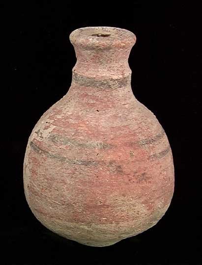 RARE POLYCHROME HOLY LAND BOTTLE: RARE POLYCHROME BOTTLE. Holy Land, c. late 2nd millennium BC. The terra cotta bottle with piriform body and stepped neck, the body red glazed with black bands. 3.25 x 4.5 inches. Rare. Provenance: An 