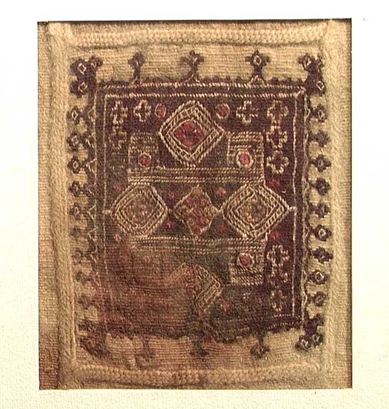 FRAMED COPTIC TEXTILE WITH CROSSES: AN EGYPTIAN COPTIC TEXTILE, c. 3rd-5th century AD. The double weave textile woven with many small Christian crosses bordering a lozenge pattern forming a large cross. 5 x 5.5 inches. Nicely framed.Pro