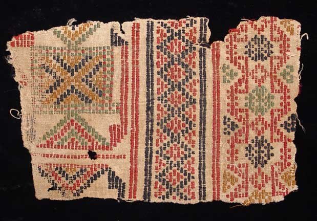 AN EARLY EGYPTIAN TEXTILE: EARLY EGYPTIAN TEXTILE FRAGMENT. Egypt, either Coptic or Islamic, c. 8th-12th century AD. The fabric with geometric designs. 4 x 6 inches. Provenance: The collection of a prominent Egyptologist by des