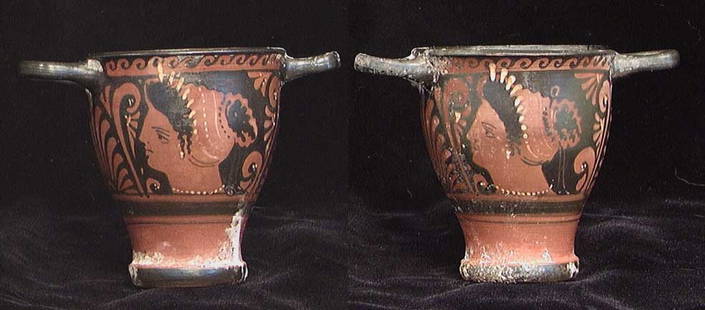 GREEK RED FIGURE SKYPHOS: GREEK RED FIGURE SKYPHOS, ca. 4th century BC. The double handled wine cup with heads of elegant ladies both sides, palmettes under the handles. 3.75 x 5.25 across handles. Intact with light deposits.P