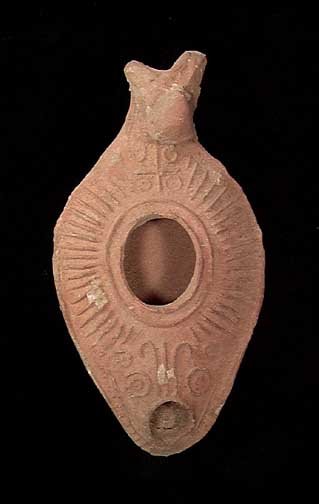 EARLY CHRISTIAN LAMP WITH CROSS: BYZANTINE TERRA COTTA OIL LAMP WITH EARLY CHRISTIAN CROSS, ca. 5th-8th century AD. The lamp with animal head handle and finely detailed raised designs including an early Christian cross by the handle.