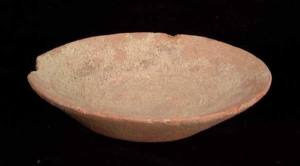 SMALL INDUS VALLEY OFFERING BOWL: SMALL INDUS VALLEY OFFERING BOWL, c. 3rd –2nd millennium BC. The shallow dish probably for offerings to local household dieties with flat base and rim. 0.5 x 2.7 inches. Rim chip. Rare. Provenance: 