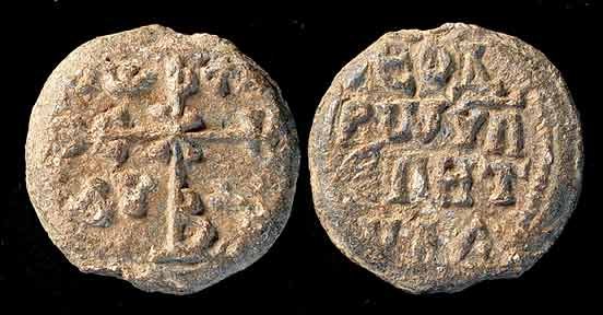 LORD HELP YOUR SERVANT!: BYZANTINE LEAD SEAL, c. 6th-9th century AD. The seal stamped with cruciform monogram one side, name of the issuing authority on the other. On the obverse there is an invocative cruciform monogram that