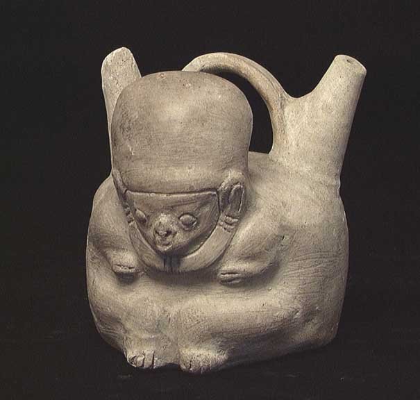 SCARCE LA TOLITA STIRRUP VESSEL: UNUSUAL TUMACO-LA TOLITA POTTERY STIRRUP VESSEL, Ecuador, c. 300 BC. The vessel with twin spouts bridged by the stirrup handle, a molded figure on the front. 5 x 5 inches. La Tolita vessels are quite 