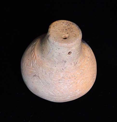 UNCERTAIN EUROPEAN IRON AGE ARTIFACT: UNCERTAIN EUROPEAN IRON AGE ARTIFACT. Central Europe, c. 1st millennium BC. 1.75 x 2 inches. Uncertain use, possibly a loom weight or gaming piece. With incised ornamentation. Rare. Provenance: An old