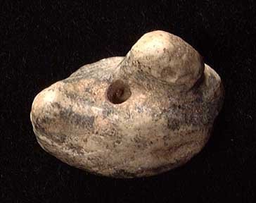 SUMERIAN DUCK WEIGHT AMULET: SUMERIAN DUCK WEIGHT AMULET, c. 3rd millennium BC. Stone carved in the form of a resting duck with reverted head resting on its back. 1". Provenance: An extensive 20th century New Jersey collection as