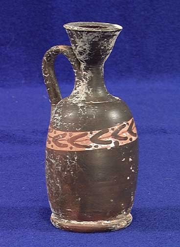 ATTIC GREEK RED FIGURE LEKYTHOS: ATTIC GREEK RED FIGURE LEKYTHOS, ca. 5th century BC. The vessel with a laurel wreath band in black figure technique around the shoulder. 4.8 inches. Intact with minor deposits. Provenance: An extensiv