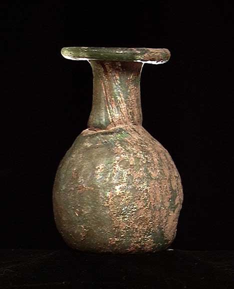 ROMAN GLASS SPRINKLER FLASK: ROMAN GLASS SPRINKLER FLASK, ca. 1st-3rd century AD. The bottle with globular base with molded honeycomb pattern, the original neck made separately and attached when the glass was hot to form a narrow