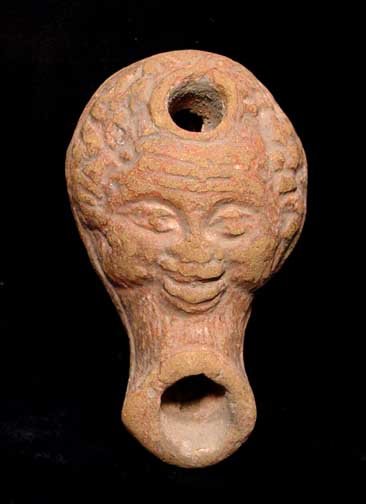 RARE ROMAN NUBIAN HEAD OIL LAMP: RARE ROMAN OIL LAMP WITH HEAD OF A BLACK AFRICAN, Roman Egypt, c. 1st-2nd century AD. The small lamp in the form of a Nubian head. 2.6 inches. A rare type. Provenance: An extensive 20th century New Je