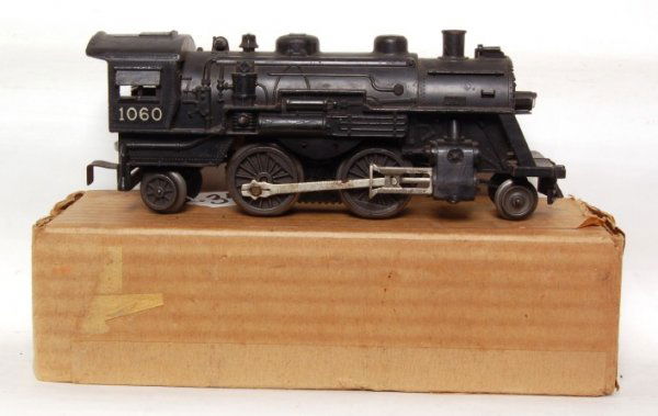 Tough Lionel 1060 steam loco in original box: Lionel 1060 steam loco, broken horn, lower C6. Includes very hard to find 1060 original box that is complete but has some sort of darkened area on it.