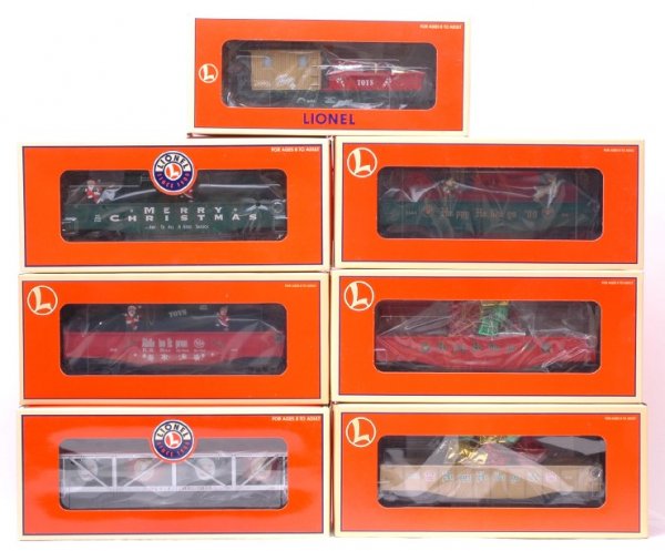 Lionel 19491 36032 36095 16795 36066 26737 MIB: Lionel seven Christmas freight cars; 19491 vat car, 36032 gondola, 36095 Santa and Mrs. Claus animated gondola, 16795 Elf and Rudolph animated gondola, 36066 gondola with presents, 26737 Mr. and Mrs.