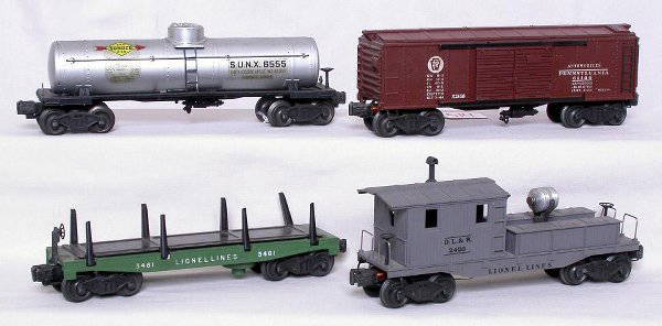 Lionel 3461, X2458, 2555 and 2420 cars: Lionel green 3461 log dump car, X2458 PRR boxcar, 6555 Sunoco tank car and a 2420 searchlight caboose.