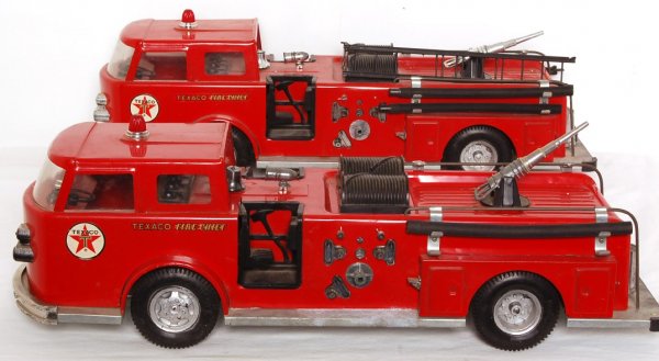 Two Buddy L Texaco Fire Chief fire trucks: Two Buddy L Texaco Fire Chief fire trucks. One truck is missing some water hose attachment trim pieces, other has light surface rust on underside, three hoses present, four ladder halves with cracked