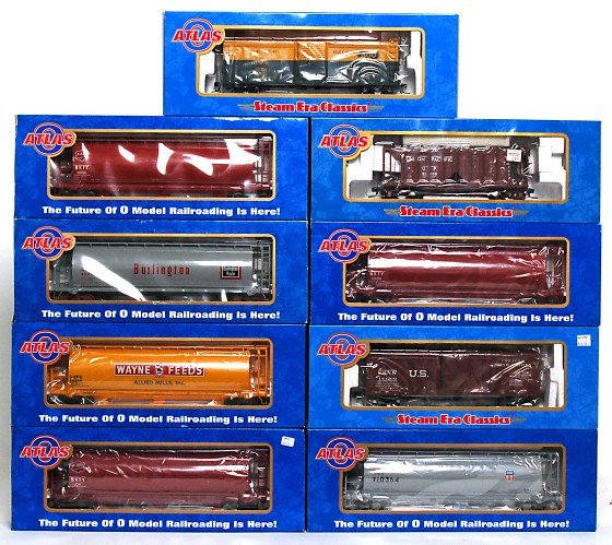 Nine Atlas freight cars in original boxes: Atlas 6304-2 MKT cylindrical hopper, 6305-2 Wayne Feeds cylindrical hopper, 6301-2 Burlington cylindrical hopper, 6304-1 MKT cylindrical hopper, 6339-2 MP/UP merger cylindrical hopper, 7481-5 C&NW ste