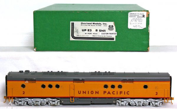 Overland Models powered brass UP E-3 B unit in OB: Overland Models, Ajin powered brass Union Pacific E-3 diesel B unit with custom paint in original box. Train has been light run, O/W looks C9 area. Box has a price sticker and a split corner.