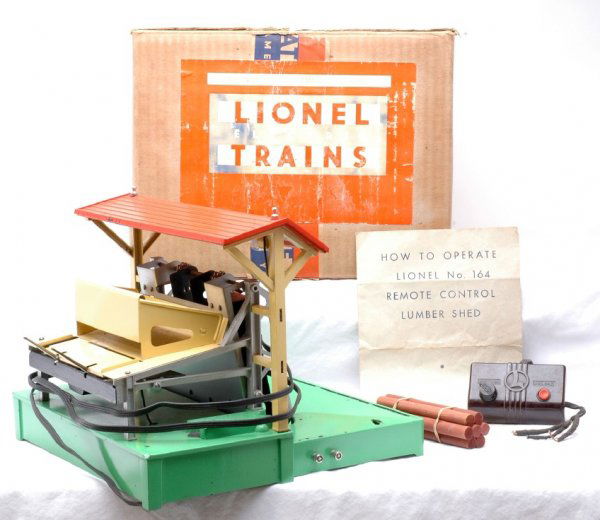 Lionel 164 Electric Lumber Loader Boxed: Lionel prewar 164 electric lumber loader in OB with original cardboard inserts, controller, instruction sheet and logs. There is some paint flaking on the roof and base, C7. The box is sealed on the b