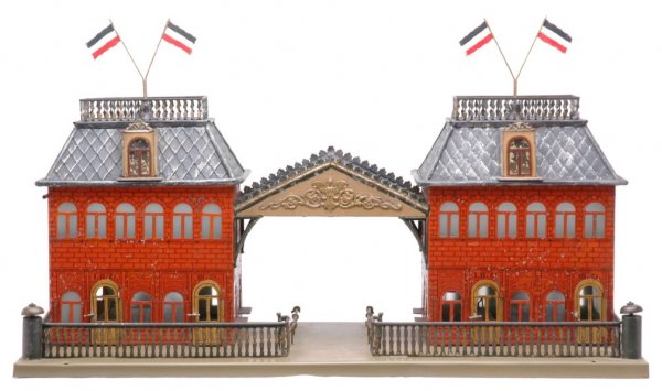 Carette 1 Gauge Lithographed Hand Painted Station: Fabulous Carette prewar 1 gauge lithographed and hand painted decorative station. Station is 24-inches in length, 9-inches in width and 13 1/2-inches high to top of flags. Station has interior with ca