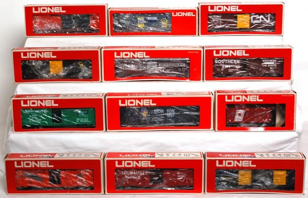 Twelve Lionel freight cars in original boxes: Lionel 9867 Hershey reefer, 9116 Domino hopper, 9723 Western Pacific boxcar, 9712 B&O automobile car, 9715 C&O boxcar, 9711 Southern boxcar, 9716 Penn Central boxcar, 9731 Milwaukee boxcar, 9115 Plant