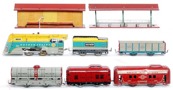 Hafner loco, tender, freight cars, station, more: Hafner 115041 key wind loco, 78100 tender 91876 gondola, 1010 tank car, 81932 Pennsylvania caboose and 3057 Hafner Streamliners caboose. Tinplate freight station and station platform. Trains look C6 a