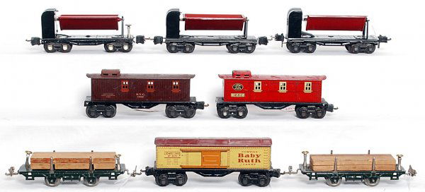 Lionel prewar two 831, three 3659, 2679, two 1682: Lionel prewar two 831 flatcars with lumber loads, three 3659 automatic dump cars, two have repainted bins and two are missing the brake wheel, 2679 Baby Ruth boxcar, two 1682 cabooses, C6 area.