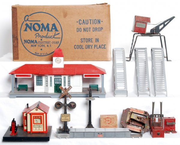 Marx train accessories and Noma talking station: Noma talking station in OB, Marx derrick, pedestrian walkover, two bumpers, signal, lamp post, and crossing with shack missing crossing arm. Please view our photographs for the best description and as