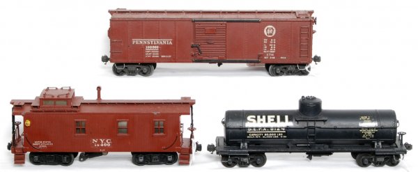 Lionel prewar scale 714, 715 and 717: Lionel prewar scale 714 PRR boxcar, has some spotting on the roof, C6. 715 scale Shell tank car, one decal has flaking, rest is C7. 717 New York Central scale caboose, catwalk is straight, frame has w