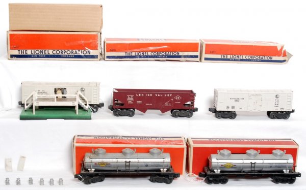 Lionel 6472, 6456, 3472, 6415, 6415 in OB: Lionel 6472 milk car, 6456 Lehigh valley hopper, 3472 operating milk car and platform (seven milk cans), 6415 Sunoco tank, 6415 Sunoco tank, in original boxes, C6 area, some cars should clean nicer. M