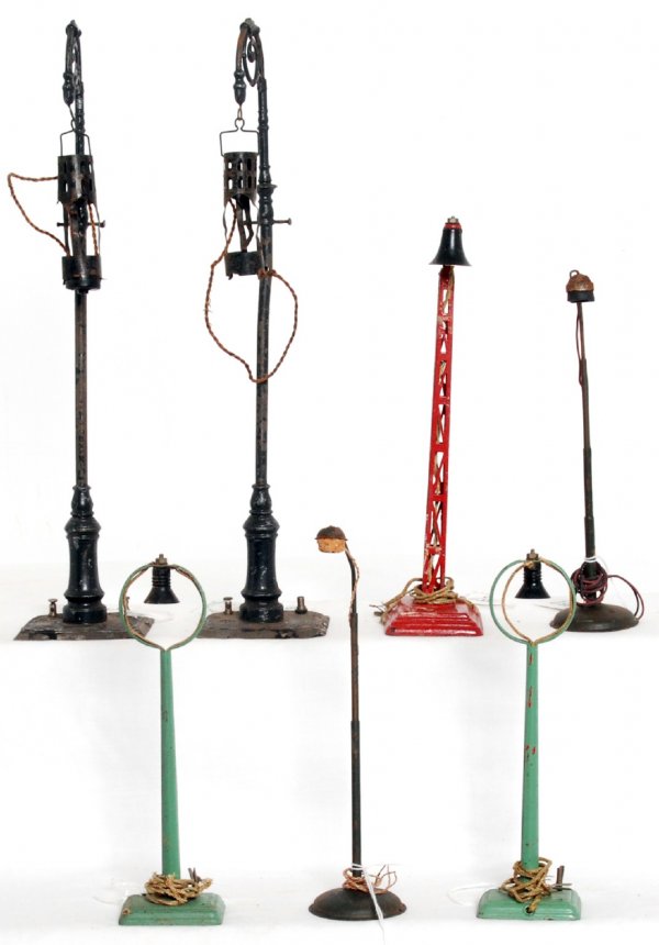 Three Marklin, two Bing, two other street lights: Three Marklin, two Bing, two other European street lights. The tallest two are Bing and are approximately 4-3/4 inches tall. Lamps look C5-6.