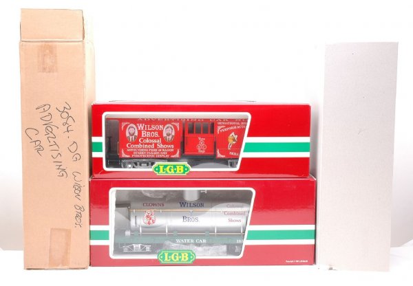 LGB Wilson Bros. Circus 3084-DG 4080-DG MINT OBs: LGB G scale Wilson Bros. Circus cars including; 3084-DG advertising car and 4080-DG tank water car in OBs with sleeves. The 3084-DG has an outer shipping carton. The cars are C10.
