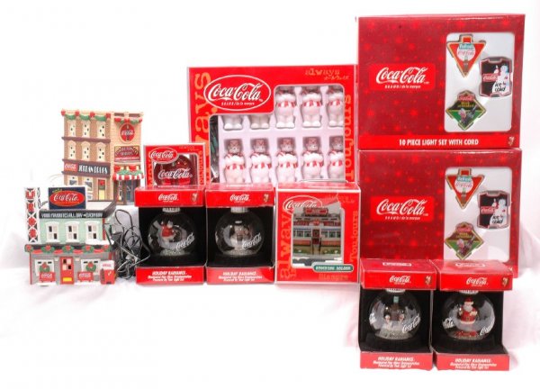 Coca-Cola Assortment of Christmas Items MINT OBs: Coca-Cola four Holiday Radiance glass Christmas ornaments, trim-a-tree ornament, stocking holder and three sets of Christmas lights factory new in original boxes. Also included are two Coca-Cola porce