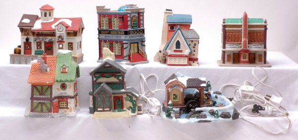 Victorian Village Santas Best Porcelain Houses LN: Victorian Village, SantaÕs Best, Lemax and Noma seven porcelain lighted buildings. One small pine tree is detached from the skating rink but is present. All items are in like new condition. Please vi