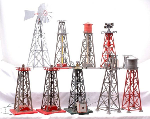 Am Flyer Accessories 769 769 772 773 774 774: American Flyer S gauge accessories; two 769 aircraft beacons, 772 water tank with small tank, 773 Oil Derrick, two 774 floodlight towers with sheds and metal windmill manufacturer unknown. Also includ
