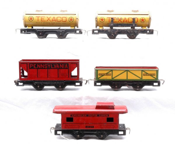 AF five Litho 31131 311267 X1128 X1128 1127: American Flyer prewar O gauge five lithographed four wheel freight cars; 311131 sand car, 311267 Pennsylvania hopper, two X1128 Texas two dome tanks, one on the wrong base and 1127 caboose. All cars a