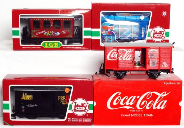 LGB G scale freight cars in original boxes: LGB G scale 36079 Christmas 1999 passenger coach, 94192 Finding Nemo aquarium car, 41350 Leikeim beer car and 45352 Coca Cola boxcar with sound, C8-10. Some boxes have a corner ding.