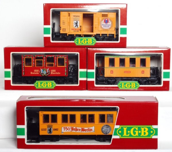 Four LGB G scale freight cars in original boxes: Four LGB G scale freight cars in original boxes, C9-10. 3006 Dodge City and Great Western passenger car, 3150 Wappenwagen 150th anniversary passenger car, 3060B 750th Berlin anniversary passenger car 