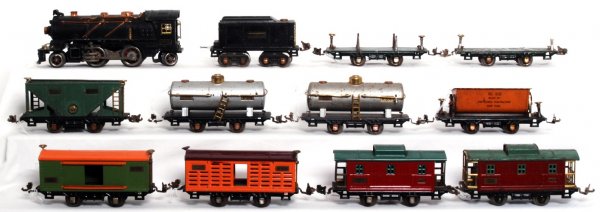 Lionel 262E, 262T, 831, 803, 804, 809, 805, more: Lionel 262E loco, 262T tender, 831 flatcar, unnumbered flatcar, 803 hopper, two 804 tanks, 809 ballast car, 805 boxcar, 806 stock car and two 807 cabooses. Loco has a bent cab corner, cars have missin