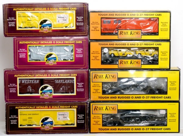 Four MTH and four Rail King freight cars in OB: MTH 20-97106 Pennsylvania PS-2 hopper, two MT-9402L National Car Co. reefers and 20-93009 Western Maryland boxcar. Rail King 30-7625 MTH auto transport flatcar w/Ertl 1959 taxis, 30-4019B Conrail engi