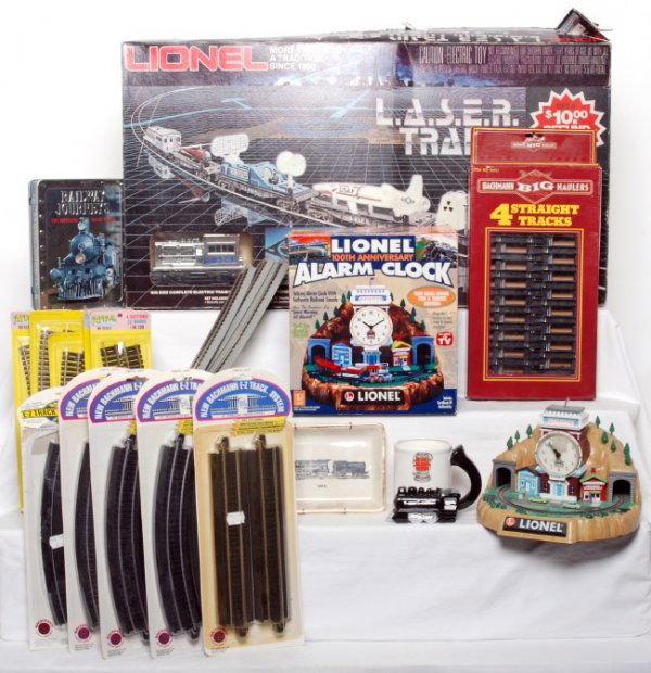 Large mixed lot of toy trains and related items: Large mixed lot of toy trains and related items. Lionel 1150 L.A.S.E.R. Train set in OB, AHM HO scale Milwaukee 4-6-2 heavy Pacific loco and tender in OB, HO freight cars, Lionel alarm clock and other