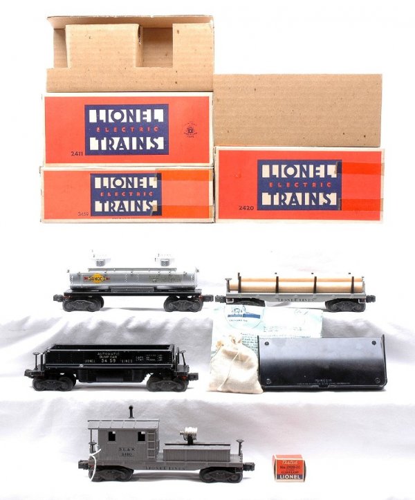 Lionel Freights 2411 2465 3459 2420 LN Boxed: Lionel postwar freight cars; 2411 flatcar with three wood logs, 2465 Sunoco tank, 3459 automatic dumping ore car with 160 black bin, bag of coal and instruction sheet and 2420 D.L.& W. work caboose wh