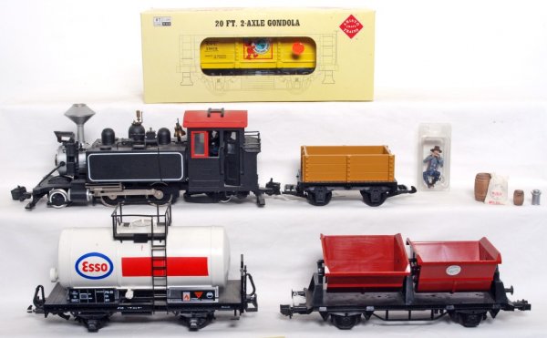 Unmarked G scale loco and four freight cars: Unmarked G scale 2-4-2T loco. LGB Esso tank. Marklin twin bin dump car. Hartland Locomotive Works gondola w/accessory trim pieces. Aristo-Craft 20 foot 2 axle gondola, gauge 1 in original box. Cars lo
