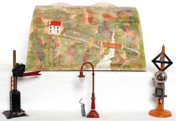 Lionel, American Flyer, Ives prewar accessories: Lionel prewar tinplate tunnel 17 inches long, 10-3/4 inches long. Ives semaphore with solder repairs. American Flyer bell ringing signal. Unmarked goose neck lamp post.